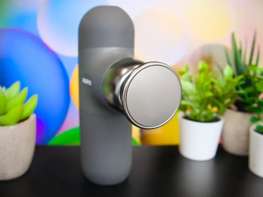 a grey device with a round knob. RENPHO Mini Thermal Massage Gun review. {Tech} for Travel. https://techfortravel.co.uk