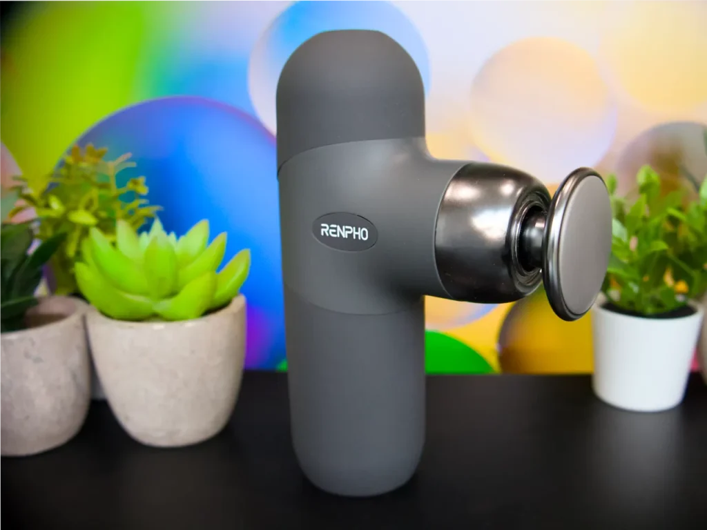 a device on a table. RENPHO Mini Thermal Massage Gun review. {Tech} for Travel. https://techfortravel.co.uk