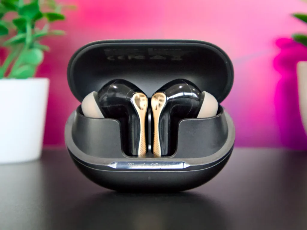 a black and gold earbuds in a case. SoundPEATS Air5 Pro Plus Review. {Tech} for Travel. https://techfortravel.co.uk