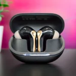 a black and gold earbuds in a case
