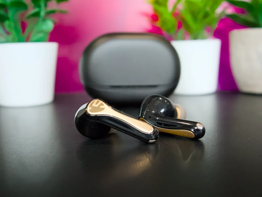 a pair of earbuds on a table. SoundPEATS Air5 Pro Plus Review. {Tech} for Travel. https://techfortravel.co.uk