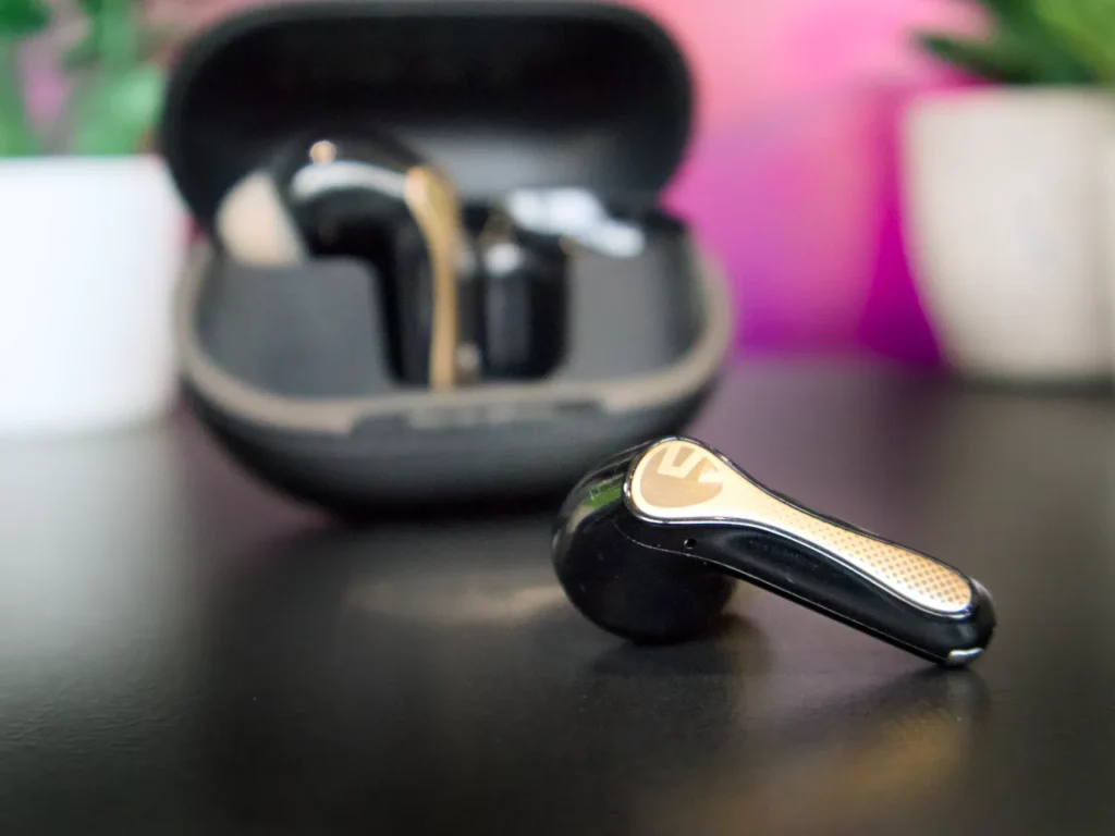 a black and gold earbuds in a case. SoundPEATS Air5 Pro Plus Review. {Tech} for Travel. https://techfortravel.co.uk