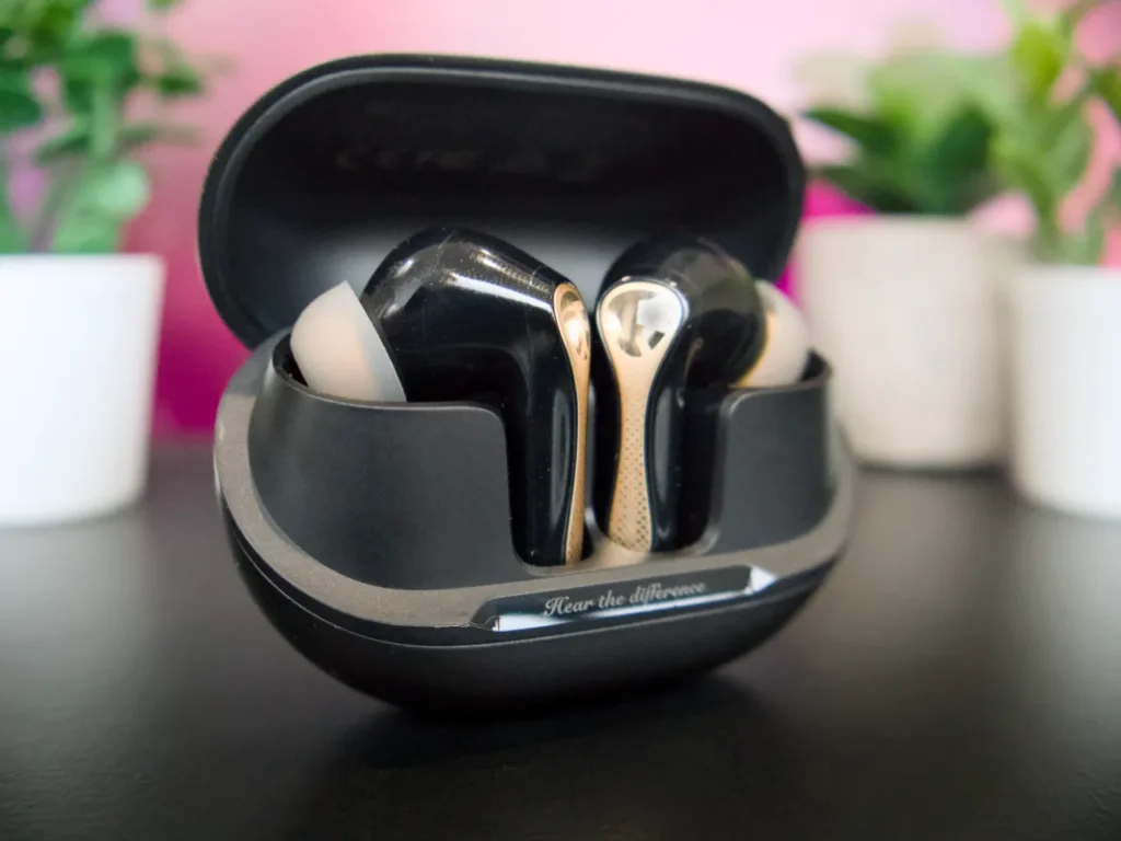 a black and gold earbuds in a black case. SoundPEATS Air5 Pro Plus Review. {Tech} for Travel. https://techfortravel.co.uk